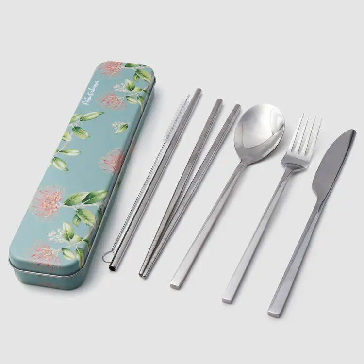 A set of portable stainless steel cutlery with a floral-patterned metal case on a light gray background. The set includes a spoon, knife, fork, chopsticks, straw, and a slim case decorated with pink flowers and green leaves.